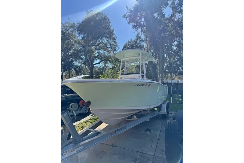 Slide: The Image of 2022 Sportsman Heritage 231 Center Console boat on trailer, parked outdoors. - 2
