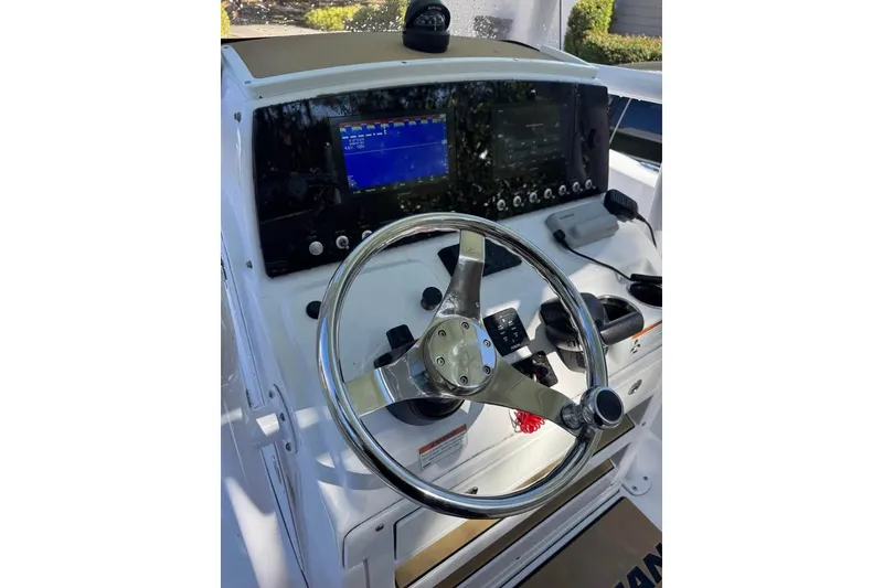 Slide: The Image of 2022 Sportsman Heritage 231 Center Console dashboard with steering wheel and navigation controls. - 6