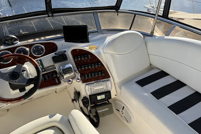 Slide: The Image of 2005 Meridian 459 Motoryacht helm with steering wheel, controls, and navigation equipment. - 14