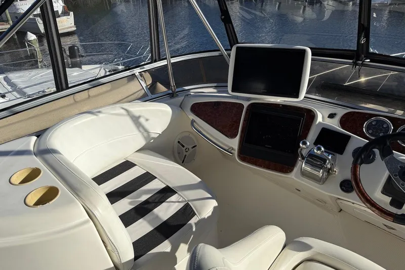 Slide: The Image of 2005 Meridian 459 Motoryacht helm with white seating and navigation equipment. - 15