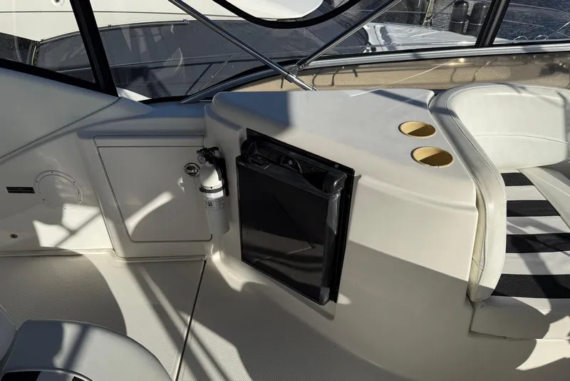 Slide: The Image of 2005 Meridian 459 Motoryacht interior with seating, cup holders, and fire extinguisher. - 17