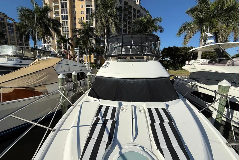 Slide: The Image of 2005 Meridian 459 Motoryacht docked, surrounded by palm trees and buildings. - 19
