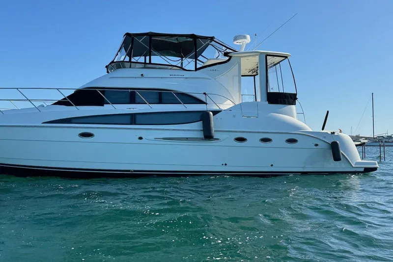 Slide: The Image of 2005 Meridian 459 Motoryacht on calm water, side view. - 2