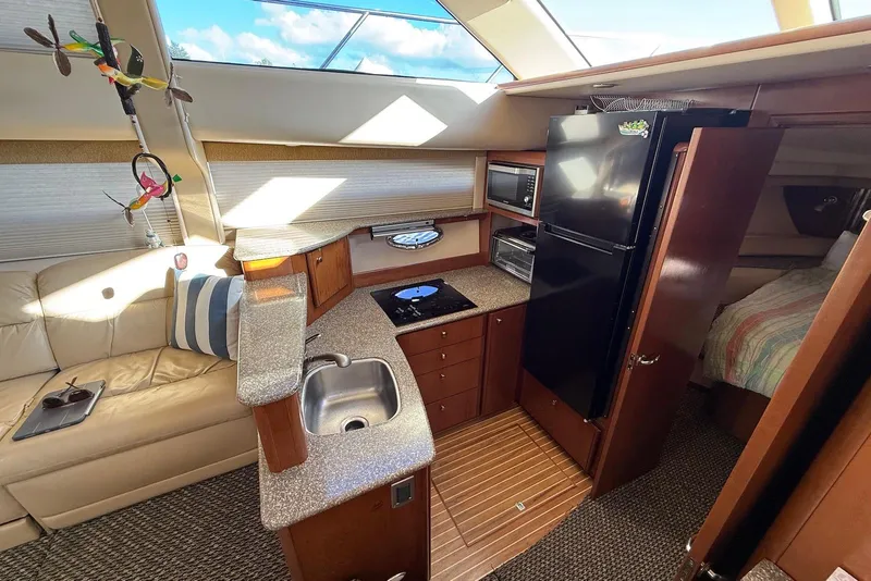 Slide: The Image of Luxurious 2005 Meridian 459 Motoryacht interior with kitchen, sofa, and modern amenities. - 25
