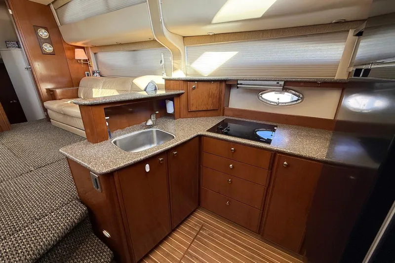 Slide: The Image of Luxurious 2005 Meridian 459 Motoryacht interior with modern kitchen and cozy seating area. - 26