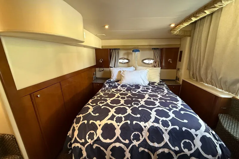 Slide: The Image of Luxurious bedroom interior of 2005 Meridian 459 Motoryacht with elegant bedding and wood accents. - 29