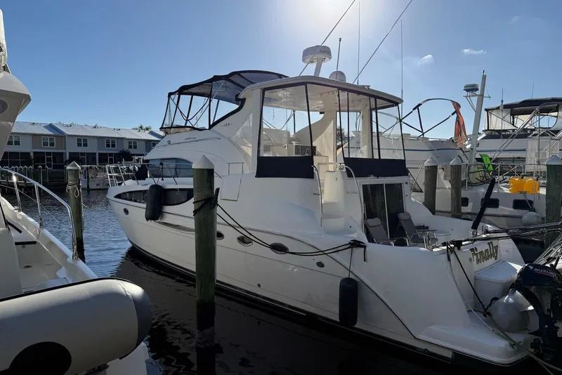 Slide: The Image of 2005 Meridian 459 Motoryacht docked in a marina under clear blue skies. - 3