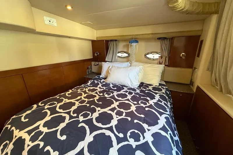 Slide: The Image of Luxurious bedroom interior of 2005 Meridian 459 Motoryacht with stylish bedding and porthole windows. - 30