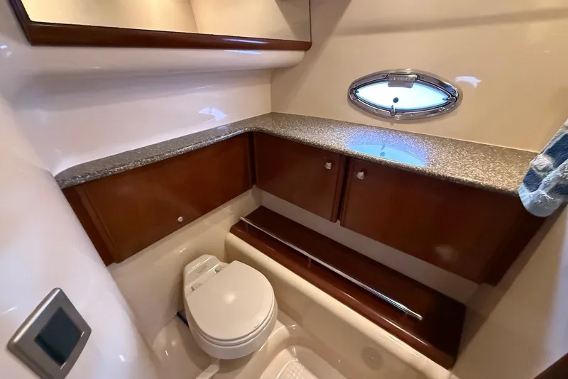 Slide: The Image of Luxurious bathroom in 2005 Meridian 459 Motoryacht with granite countertop and porthole window. - 33