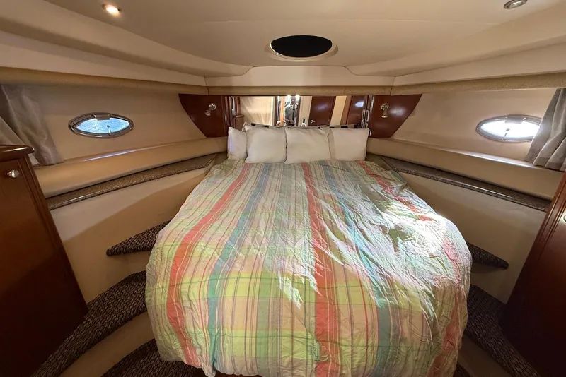 Slide: The Image of Luxurious 2005 Meridian 459 Motoryacht bedroom with colorful bedding and elegant wood accents. - 35
