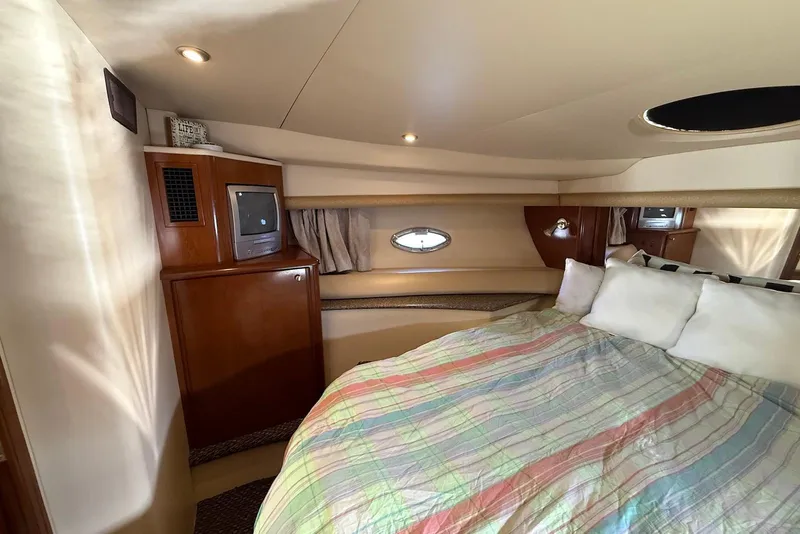 Slide: The Image of Luxurious 2005 Meridian 459 Motoryacht bedroom with cozy bedding and vintage TV. - 37
