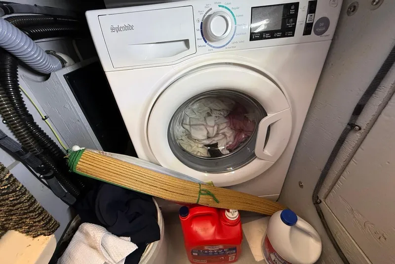 Slide: The Image of Laundry area on 2005 Meridian 459 Motoryacht with washing machine and cleaning supplies. - 39