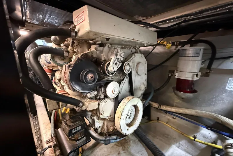 Slide: The Image of Engine room of 2005 Meridian 459 Motoryacht, showcasing mechanical components and hoses. - 43
