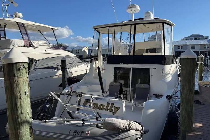 Slide: The Image of 2005 Meridian 459 Motoryacht docked at marina under clear blue sky. - 5