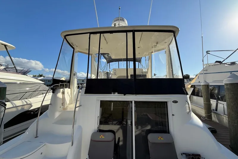 Slide: The Image of 2005 Meridian 459 Motoryacht docked under clear blue sky. - 7