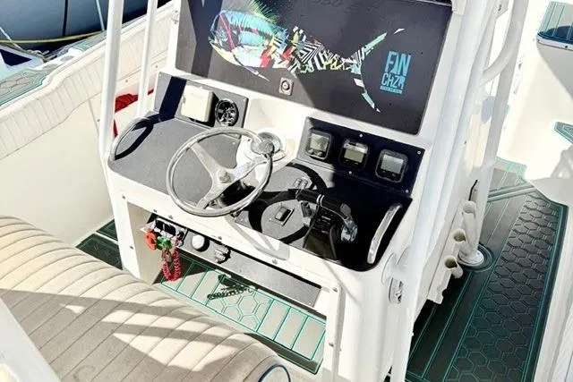 Slide: The Image of 1997 Marlin Yachts 350SF boat cockpit with steering wheel and control panel. - 10