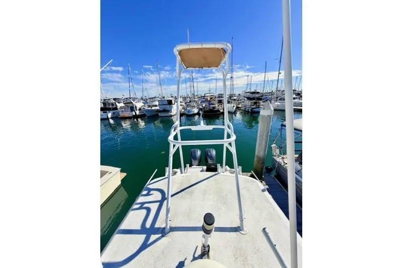 Slide: The Image of 1997 Marlin Yachts 350SF at marina, clear sky, calm water, docked boats. - 16