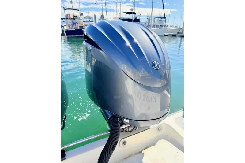 Slide: The Image of Outboard motor on 1997 Marlin Yachts 350SF, docked in marina with boats in background. - 18