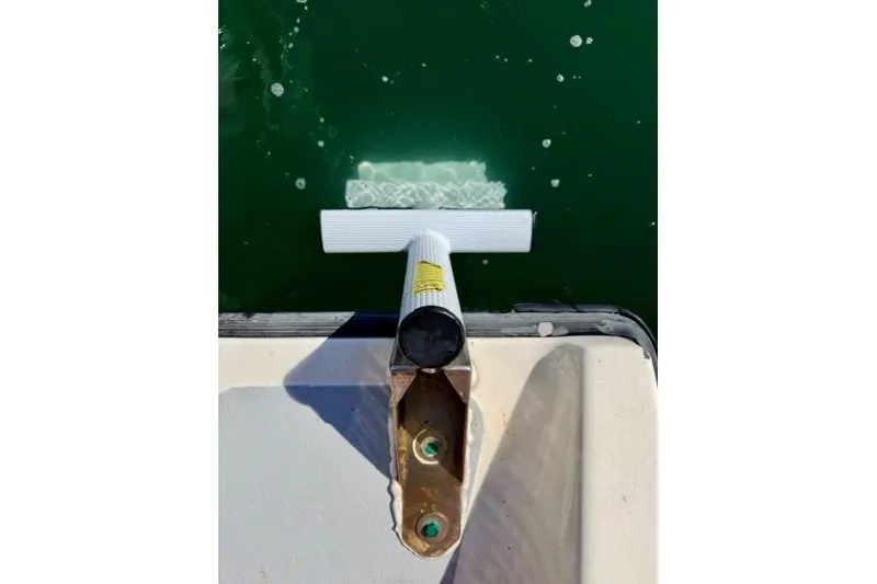 Slide: The Image of Marlin Yachts 350SF 1997 boat ladder extending into green water. - 19