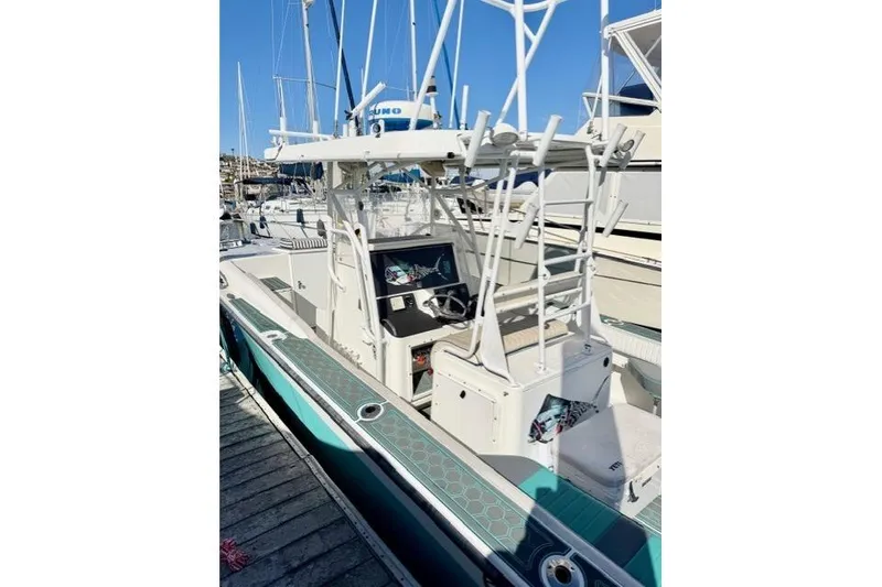 Slide: The Image of 1997 Marlin Yachts 350SF boat docked, featuring a sleek design and modern equipment. - 9