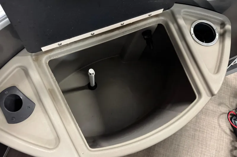 Slide: The Image of 2024 Sun Tracker Fishin' Barge 20 DLX livewell with cup holders and storage compartments. - 10