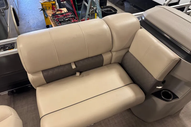Slide: The Image of 2024 Sun Tracker Fishin' Barge 20 DLX beige and gray seating with cup holder. - 11
