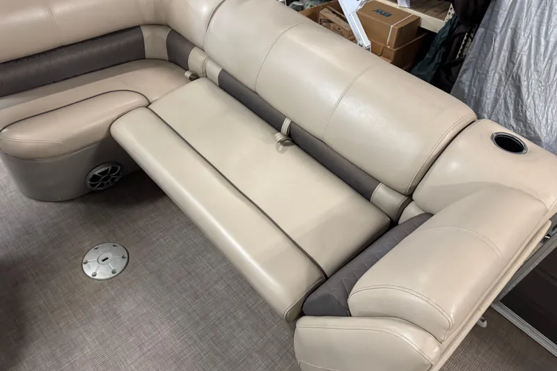 Slide: The Image of 2024 Sun Tracker Fishin' Barge 20 DLX interior seating with cup holder and speaker. - 13