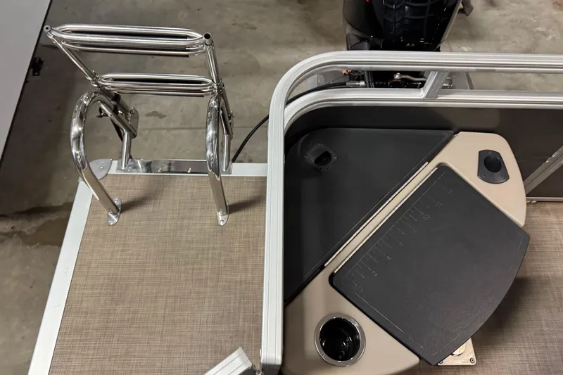 Slide: The Image of 2024 Sun Tracker Fishin' Barge 20 DLX boat deck with ladder and seating area. - 19