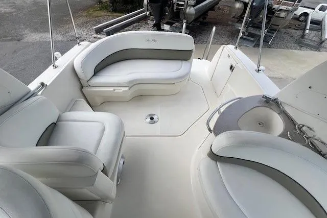 Slide: The Image of 2006 Sea Ray Sundancer 260 boat interior with white seating and compact layout. - 15