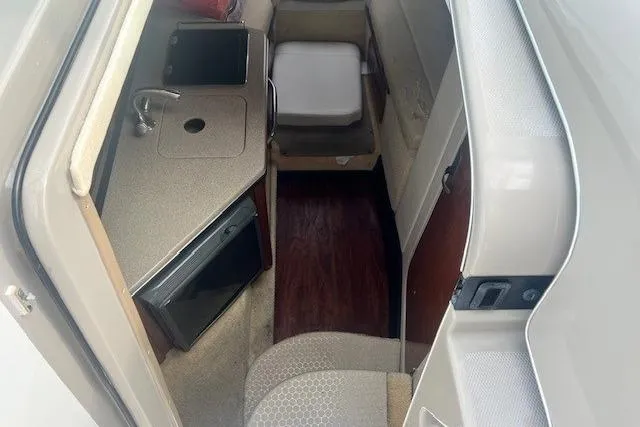 Slide: The Image of 2006 Sea Ray Sundancer 260 cabin interior with kitchenette and seating area. - 17