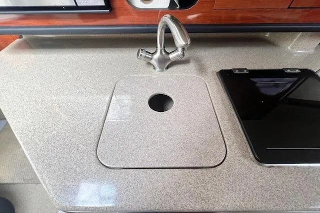 Slide: The Image of 2006 Sea Ray Sundancer 260 interior with sink and countertop detail. - 22