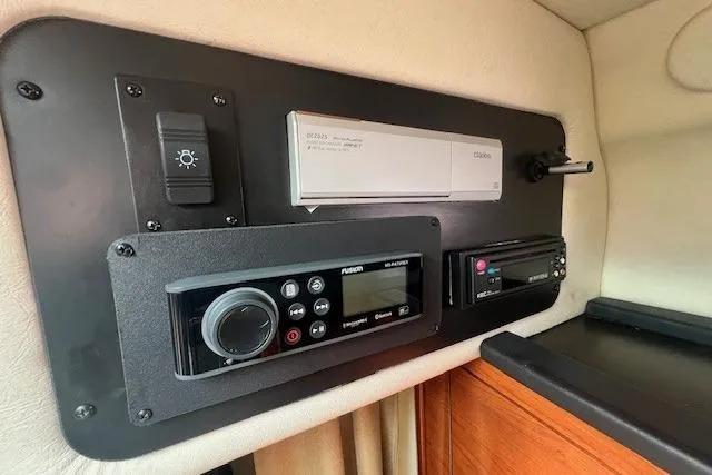 Slide: The Image of Control panel of 2006 Sea Ray Sundancer 260 boat with navigation and audio systems. - 24