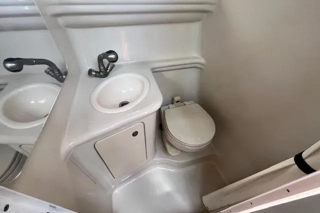 Slide: The Image of 2006 Sea Ray Sundancer 260 bathroom with sink and toilet, compact marine design. - 26