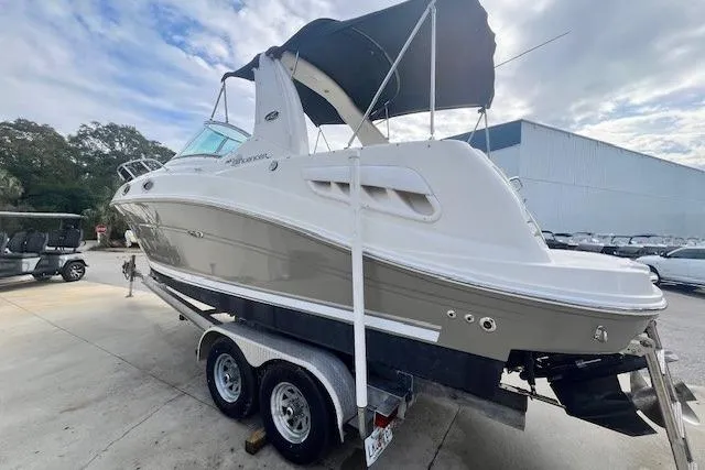 Slide: The Image of 2006 Sea Ray Sundancer 260 boat on trailer, parked outdoors under cloudy sky. - 4