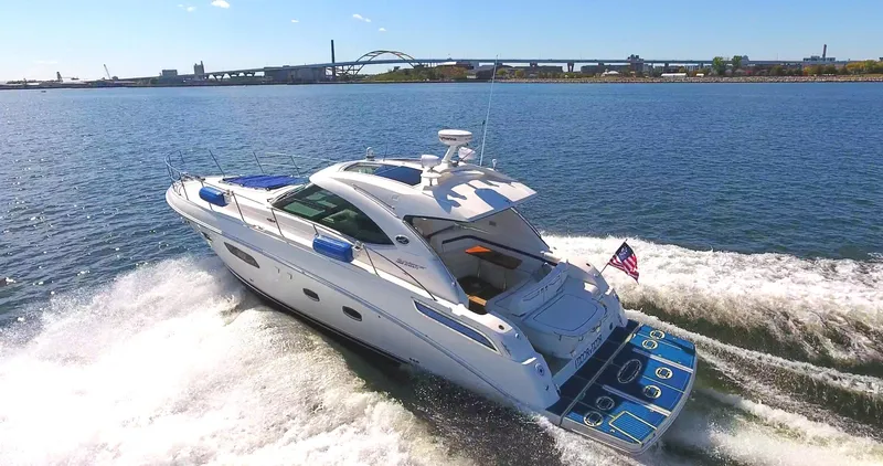 The Image of 2011 Sea Ray 470 Sundancer cruising on open water, rear view. - 0