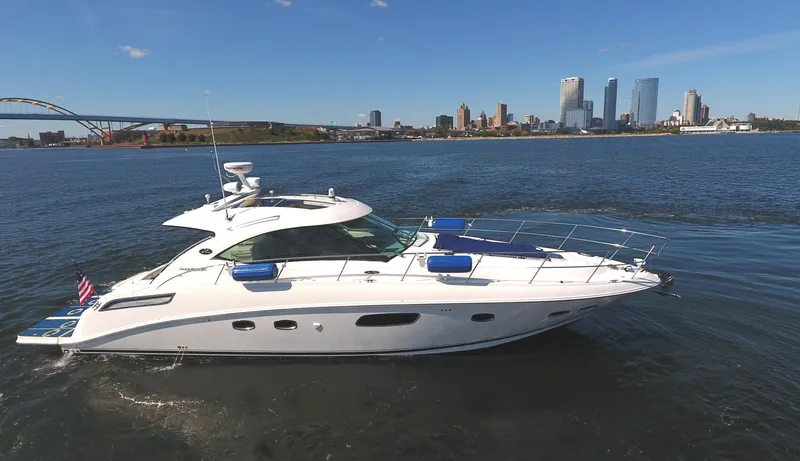 Slide: The Image of 2011 Sea Ray 470 Sundancer yacht cruising near city skyline. - 11
