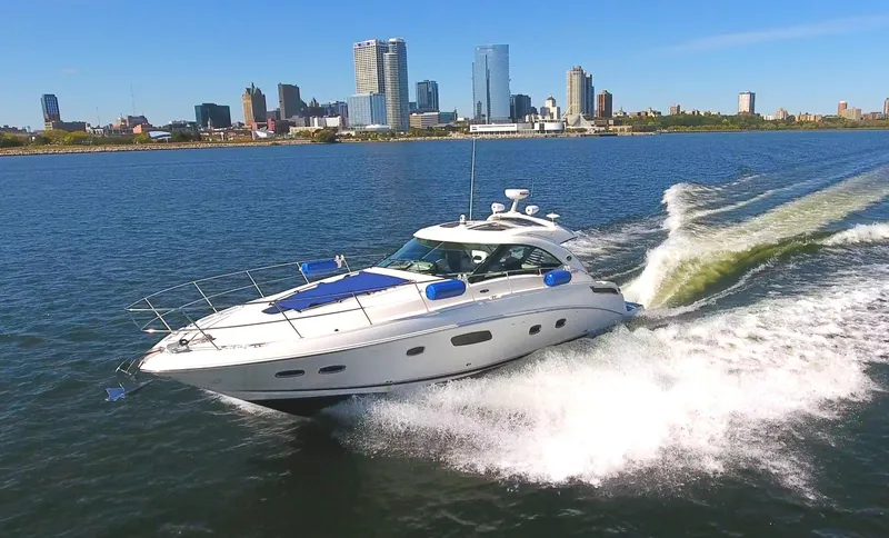 Slide: The Image of 2011 Sea Ray 470 Sundancer cruising on a sunny day near city skyline. - 13