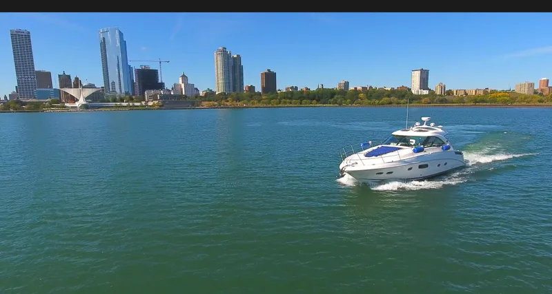 Slide: The Image of Sea Ray 470 Sundancer 2011 cruising on a city waterfront with skyline view. - 15