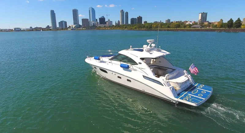 Slide: The Image of 2011 Sea Ray 470 Sundancer yacht cruising near city skyline. - 18