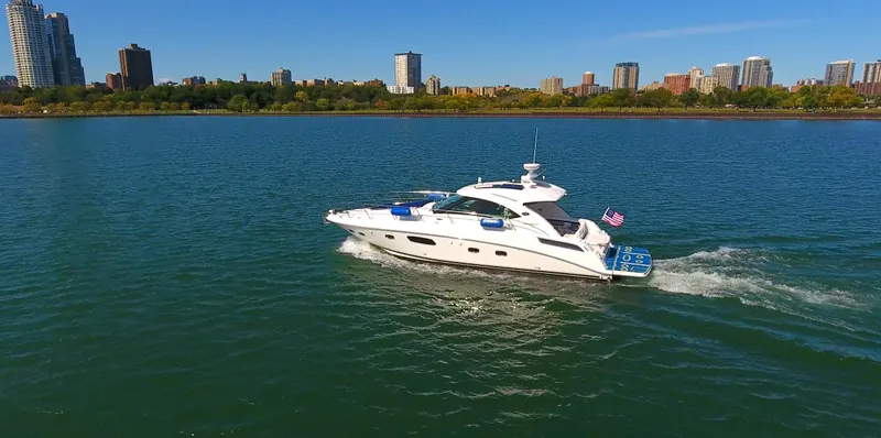 Slide: The Image of 2011 Sea Ray 470 Sundancer yacht cruising on a scenic urban waterway. - 22