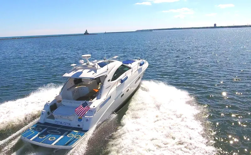 Slide: The Image of 2011 Sea Ray 470 Sundancer cruising on open water, rear view. - 24