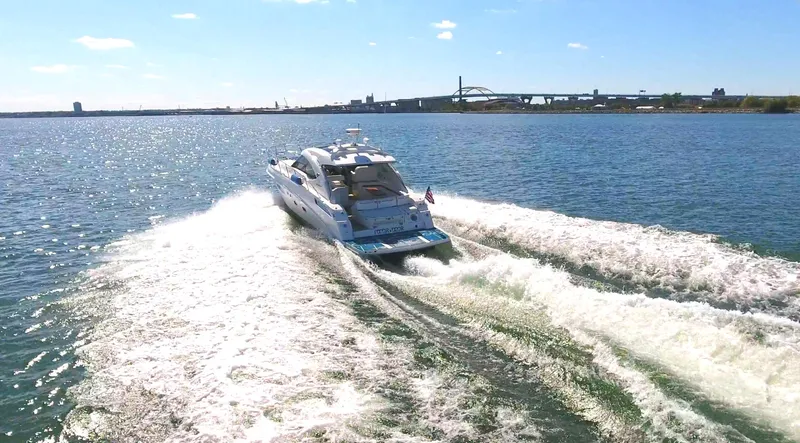 Slide: The Image of 2011 Sea Ray 470 Sundancer cruising on open water, leaving a wake behind. - 26