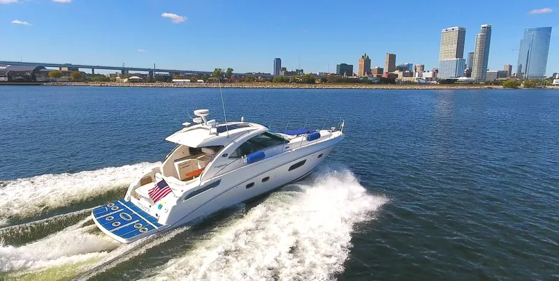 Slide: The Image of 2011 Sea Ray 470 Sundancer cruising on a sunny day near city skyline. - 28