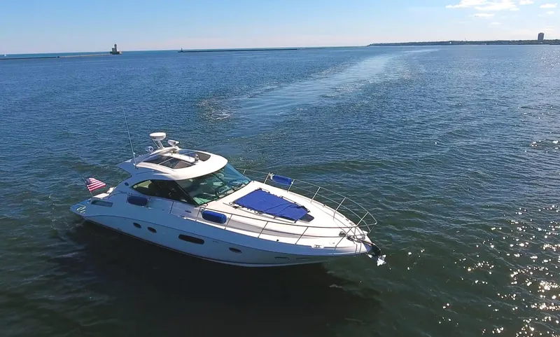 Slide: The Image of 2011 Sea Ray 470 Sundancer yacht cruising on open water. - 3