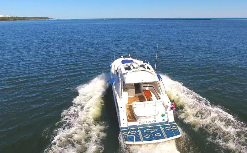 Slide: The Image of 2011 Sea Ray 470 Sundancer cruising on open water, rear view. - 30