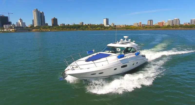 Slide: The Image of 2011 Sea Ray 470 Sundancer cruising on a sunny day near city skyline. - 32