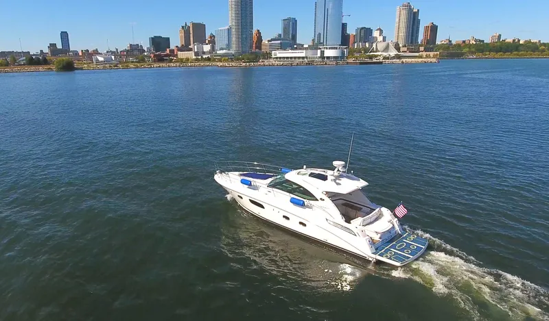 Slide: The Image of 2011 Sea Ray 470 Sundancer cruising on a city waterfront. - 35