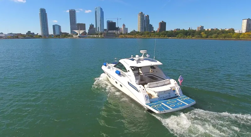 Slide: The Image of 2011 Sea Ray 470 Sundancer yacht cruising near city skyline on a sunny day. - 36