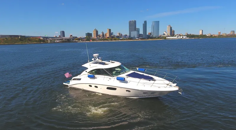 Slide: The Image of 2011 Sea Ray 470 Sundancer yacht cruising near city skyline. - 4