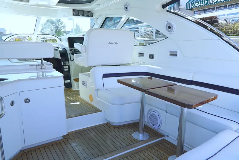 Slide: The Image of Interior of 2011 Sea Ray 470 Sundancer yacht with sleek seating and wooden table. - 41